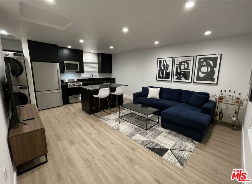 Northridge / North Hills West Showstopper! Check out this brand-new, luxurious detached single-family guesthouse with no shared walls. Enjoy privacy with its own entrance and a fenced private patio.  Step into a Chef's kitchen featuring a new stainless-steel slide-in range/oven, a refrigerator with ice maker, a vented SS microwave hood, an SS dishwasher, and an undermount sink with garbage disposal. Sleek, modern matte-black cabinetry, black marble countertops, and a generous island prep station make this kitchen an entertainer's dream. Adjacent laundry area includes a new LG Smart full-size stacked washer & dryer, no trips to the laundromat, ever.  Enjoy the comfort and efficiency of all-new systems: HVAC, LED recessed lighting, new plumbing, new electrical with SOLAR PANELS (little to no electric bill, depending on usage), dual-pane windows, new roof, fresh interior paint, and laminate flooring throughout. The spa-inspired bathroom feels like a boutique hotel: marble flooring, a 36-inch vanity with extra linen storage above the toilet, a high-end toilet, a frameless glass shower door, Delta fixtures, a beautifully tiled shower with three shampoo niches, a lighted vanity mirror, and marble countertops. Outside, relax or entertain on your private patio with concrete pavers, perfect for an outdoor seating area or container garden. A new front gate with electronic keyed access adds convenience, privacy, and peace of mind. Set in a neighborhood known for its strong sense of community and neighborly feel, this rare offering truly has it all.  Contact the property manager or your real estate agent directly. Beware of rental scams. This home is not offered as rent-to-own and is not listed on Craigslist.