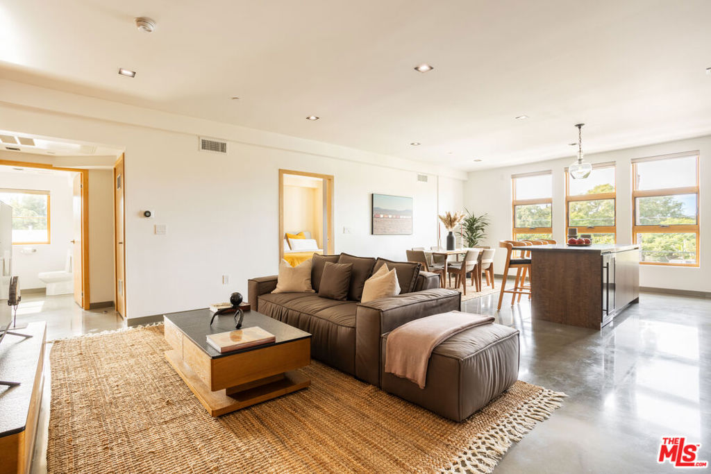 Making its debut in one of West Hollywood/Beverly Grove's most coveted locations, 547 Sweetzer is a brand-new contemporary building bringing modern design, elevated amenities, and boutique-quality living to the neighborhood. This spacious 2 bedroom, 2.5 bathroom residence showcases polished concrete floors, oversized windows with remote-control power shades, Nest-controlled central heat and air, and an open-concept layout with a sleek kitchen outfitted with brand-new appliances. Both bedrooms are private suites with spa-inspired bathrooms, complemented by a stylish powder room and thoughtful storage throughout. Residents enjoy an expansive rooftop sundeck with sweeping city views, a 24-hour camera security system, and a gated subterranean garage with two side-by-side parking spaces plus a private storage unit. Available furnished or unfurnished, this home blends modern luxury with everyday convenience-just steps from Melrose Place, West 3rd Street, and Beverly Boulevard's premier dining, cafes, and boutiques.