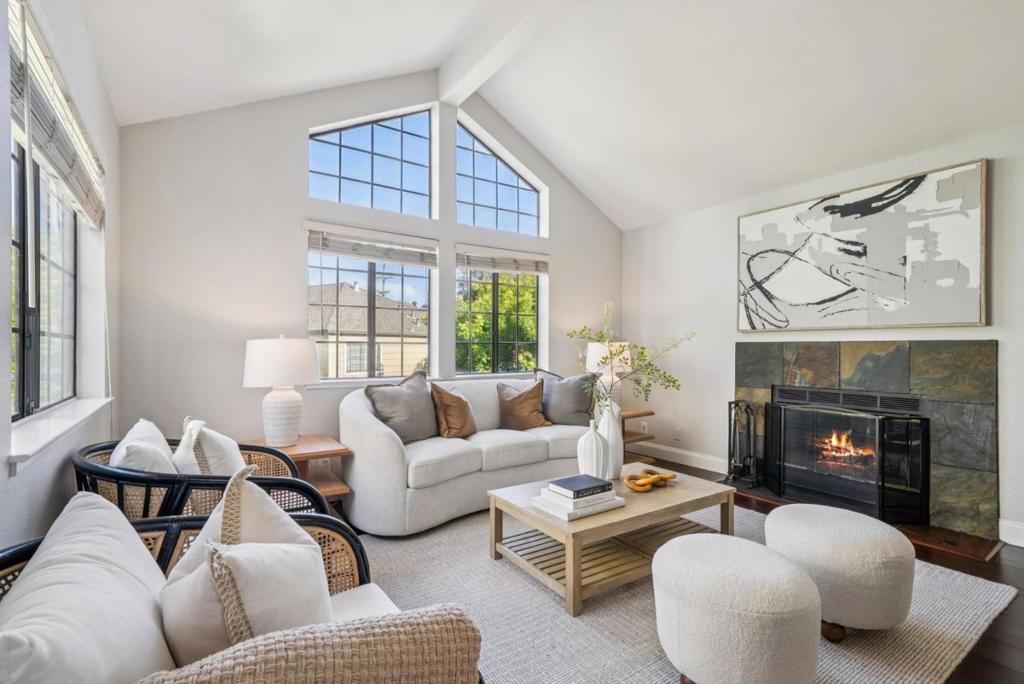 Spectacularly remodeled corner unit showcasing high-end finishes and sophisticated style! This 2-bedroom, 2-full bathrooms home, 1,067 sq.ft. impresses with vaulted ceilings, abundant natural light, central A/C & heat, wood-burning fireplace, and a private balcony with serene hillside and sunset views. Gleaming bamboo flooring throughout. The chefs kitchen features stainless steel appliances, granite countertops, and designer tile accents. Two luxurious bathrooms include a spa-like primary retreat with deep oversized tub, dual shower heads, and custom tile. Bedrooms boast upgraded closet systems with sleek mirrored doors. Enjoy the convenience of an in-unit oversized Samsung washer/dryer, Ring doorbell, and two parking spaces: one in an enclosed shared garage and one reserved. Nestled in a quiet, well-kept community near the Communications Hill loop trail, grand staircases, and neighborhood parks. Close to shops, dining, and freeway access. HOA covers water, cable, garbage, landscaping, and more. A turn-key opportunity for luxury living or a prime investment in a highly desirable location!