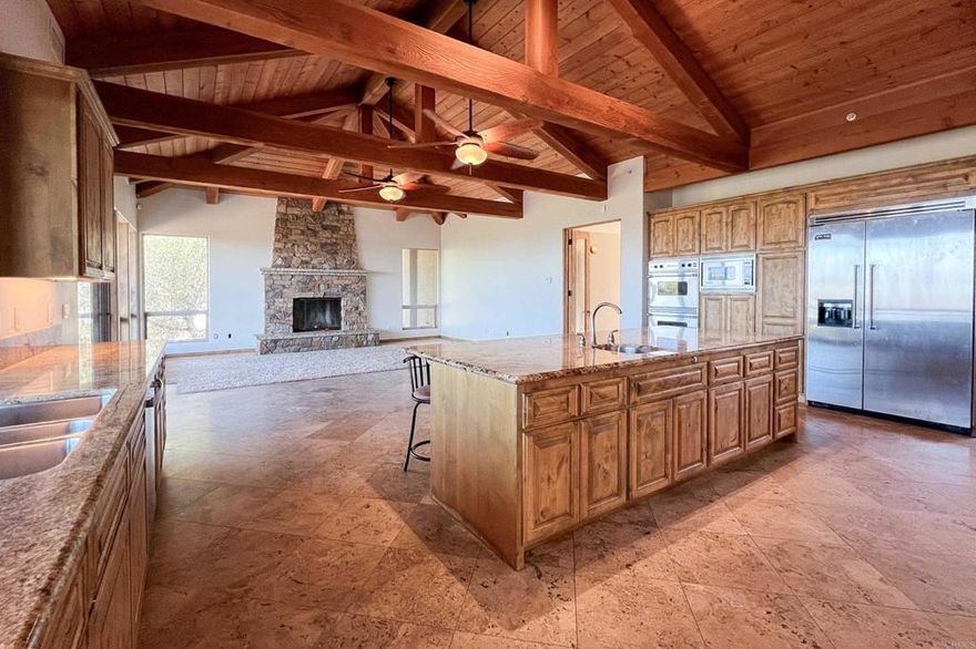 Now that rates are down, embrace life with the serenity of 25 acres and a beautiful custom home. At almost 6000 sqft. coupled with stunning panoramic views stretching all the way to the coastline. This house lives like a single level home with the added benefit of 2 huge bonus rooms above the garage, w/hardwood plank flooring, a kitchenette, and a private deck. Spacious primary suite where even the walk in closet has a closet. Entertain with ease in the gourmet kitchen with butlers pantry. Elegant travertine floors on the main level, granite countertops, and viking appliances. Stunning "Romeo and Juliette" indoor balcony and 2 wood burning fireplaces. Car enthusiasts and hobbyists will love the expansive garage with three 10'x8' insulated roll-up doors and approx. 27' of depth. Home includes dual hot water heating systems and a central vacuum system. Outside decking, prewired for theater and pre-plumbed for kitchenette. A rooftop observation deck, affectionately known as the "Hawk’s Nest," offers a perfect perch to take in sunset skies and star-filled nights. Room for a pool /spa area. This is an amazing opportunity for the savvy buyer.