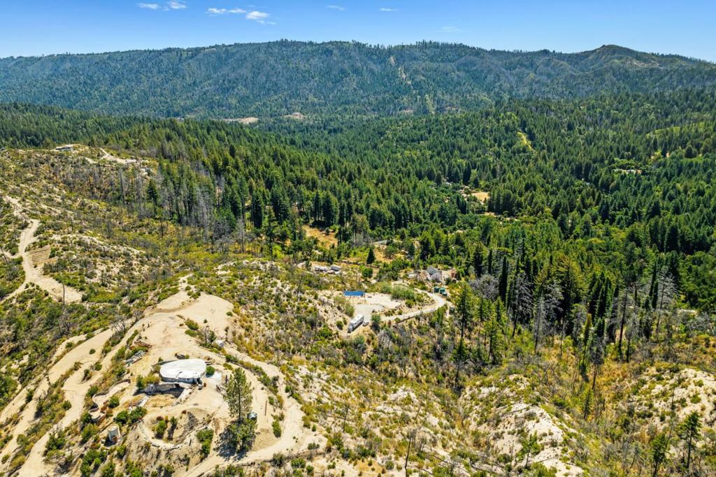 Nestled atop the serene Santa Cruz Mountains, 500 Hill House Road offers a rare combination of peace, privacy, and panoramic 270-degree views. This nearly 2.5-acre parcel is the crown jewel of Boulder Creek a fully pre-cleared, end-of-the-road retreat with over $160,000 in post-fire capital improvements already completed. Perched at the top of the hill, the property boasts an enormous, level building site, making it ideal for your dream home or a stunning weekend escape. Existing infrastructure includes electricity, certified well and water lines, Xfinity cable & high-speed internet, and a saltwater swimming pool with equipment ready for relaxing or entertaining while you build. Recent improvements include: Solar-powered electric gated entry, Retaining walls, Septic system, Well & shared water access, Hose bib at building site, Surveyed parcel. Plus, the property will be connected to Big Basin Water when new neighborhood tank is completed offering future-proof reliability. Just 10 minutes from downtown Boulder Creek and 5 minutes from BC Golf Course, this parcel combines the tranquility of mountain living with unbeatable convenience. If you're looking for a peaceful retreat, a development opportunity, or a forever home site, here is the best-valued parcel in the region.
