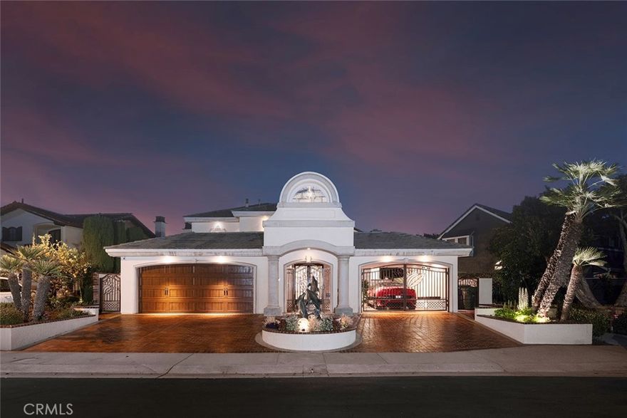 Just over 100 properties occupy what is widely regarded as Huntington Harbour’s most desired 24 hour guard-gated enclave – Coral Cay. Recently reimagined to reflect a contemporary aesthetic this estate-style property is set within the quiet curve of the idyllic neighborhood’s private marina. The over 5,800 square-foot parcel’s position enjoys delightful views from nearly every vantage – including a charming panorama of the on-water lifestyle, and the sparkling Main Channel. The nearly 4,000 square feet of dwellings are both accommodating and well designed – affording residents an elegant, yet comfortable surround for modern living, dining, and relaxation, as well as the attributes for large-scale or intimate gatherings. Along with the addition of steel beams to open up the first level of the generously appointed four-bedroom, three-bath home – the interior is replete with amenities and fine finishes – including walls of windows and glass, capturing captivating waterfront vistas; abundant employment of hardwoods and stone; a graphic, bespoke curved glass stair; over-height ceilings; a fully-equipped bar with a ‘living ecosystem’, 175-gallon exotic fish tank, beverage refrigeration, and an adjacent games or billiards room; a culinary enthusiast’s kitchen with a Wolf range, and built-in heat lamps; dual Sub Zero refrigerators, warming drawers, ice maker, dual sinks, a primary spa-like bath with a custom granite soaking tub and arced glass shower; a tankless water heater, new generator, dual-zoned HVAC, and soft water systems; and an office and fitness room – both easily converted to ancillary bedrooms. The exterior, of equal refinement, is complemented by its vast water frontage; an expansive terrace enjoying both sun-filled and covered spaces for enjoyment, a plunge pool, and a deep-water dock with capacity for an up to 40’+ craft. Coral Cay boasts a pristine private beach, pickle ball and tennis courts. Further distinguishing this extraordinary property is optimal walking distance to the local beaches and the area’s finest cultural, social, and recreational offerings and resources.