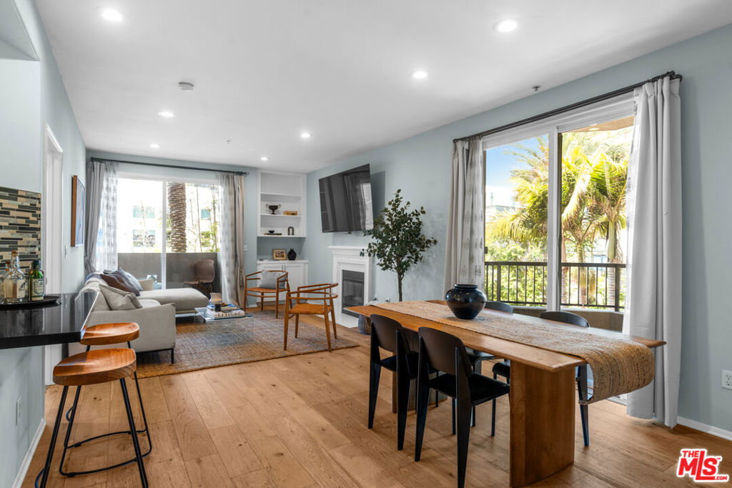 Commanding a notable presence in the lively Marina Arts District, this spacious and sunlit 3-bedroom, 3-bath condo offers the rare combination of exclusivity and accessibility. Located in a private wing of the desirable Del Rey Terrace community with low HOAs and numerous amenities, the front-facing unit enjoys lush pool and city views, with no shared walls and three private balconies - your personal invitation to indoor-outdoor SoCal living.//From your private entry walkway, step inside and find a home that feels truly special, where thoughtful upgrades and comfort go hand in hand. The kitchen offers upgraded black quartz countertops, under-cabinet and drawer lighting, a breakfast bar, and stainless steel appliances that invite culinary creativity. The open-concept living area welcomes you with the warmth of a fireplace, framed by views of mature green palms and purple jacarandas through expansive sliding glass doors. It's a space equally suited to entertaining or relaxing, with recessed lighting throughout and a 77" OLED TV on a wall-mounted pull-down swivel arm - yours to keep. //The primary suite offers a quiet sanctuary, complete with a walk-in closet and ensuite bath, while the secondary bedroom is just as inviting - boasting its own ensuite, private balcony, and serene pool view. A third bedroom provides the flexibility to serve as a home office or ample space for more family or guests. //The benefits of a 2000s build include effective dual-pane windows and sliding doors, so you can enjoy the breathing room, light and views that a front-facing unit offers, yet also retain the peaceful quiet inside from the bustling activity below. Additional comforts include central AC and heating, in-unit laundry, and plenty of storage throughout. Smart-home touches elevate the everyday: smart light switches, Nest thermostat, a Ring alarm system on every window and door, and an HOA-approved Lockly smart lock with fingerprint access, giving your home an effortless feel of extra comfort, security and protection. //Whatever mode of transportation you prefer, you can be nearly anywhere in minutes - ride the bike path to the beach, hop on a boat to the other side of the marina, or walk to the dine-in movie theater or one of the many bars and restaurants in the immediate neighborhood. There is quick access to the 90 fwy for venturing further, and your two side-by-side parking spots in the gated garage include a dedicated 9KW EV charger. And yet with so much around you, with the resort-style amenities offered in your community - heated pool and spa, fitness center, clubhouse, media room, package lockers and code-secured bike storage room - you'll find everything you need right at home!