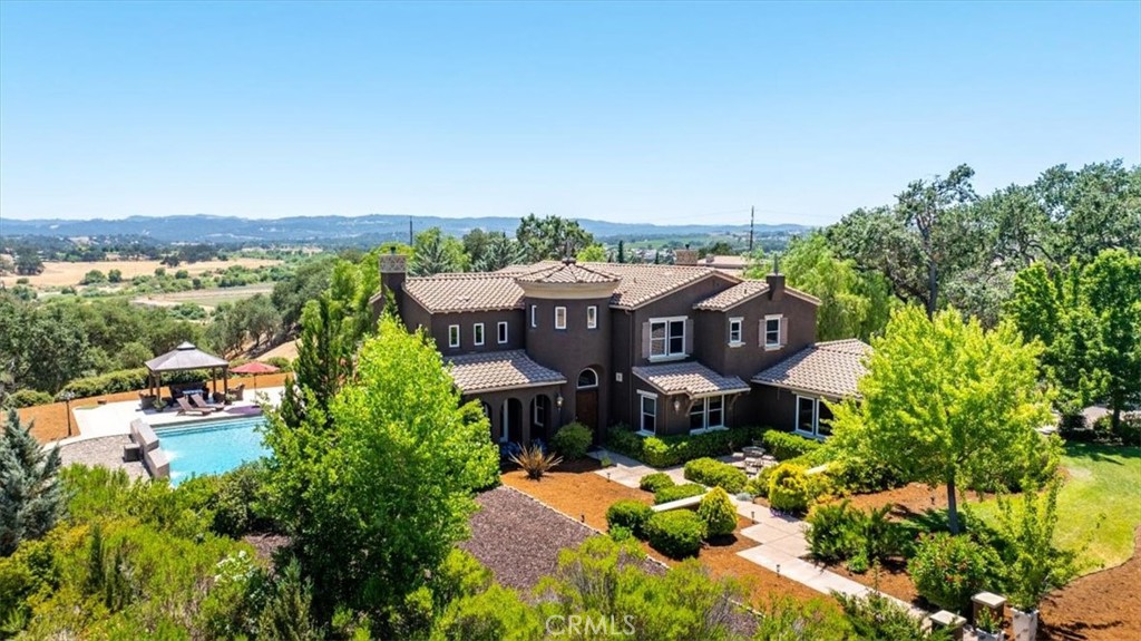 Welcome to your private retreat in the prestigious, guard-gated community of Santa Ysabel Ranch in Templeton, California. This stunning, spacious 4-bedroom, 3.5-bathroom estate sits on 1.35 beautifully landscaped acres, offering the perfect blend of luxury, comfort, and tranquility.
Step into the inviting and open first-floor layout designed for seamless entertaining or relaxed family living. High ceilings and expansive windows bathe the home in natural light, creating a warm and welcoming atmosphere throughout. The gourmet kitchen is a culinary dream—equipped with GE Monogram appliances, including a built-in refrigerator/freezer and double ovens and compactor—perfect for everything from preparing elaborate meals or creating a yummy charcuterie tray and pairing it with a wonderful wine!
The backyard is a true sanctuary, featuring a large, sparkling pool ideal for floating under the sun or swimming laps for exercise. The cascading waterfalls and fountains are truly mesmerizing! Whether you're hosting guests or enjoying a peaceful moment alone, this outdoor space is a showstopper. There is a small panel of solar for pool heating as well as a gas pool heater for the warm water lovers! Meander down the walkways to capture the true beauty of the property. The views from the backyard are breathtaking as you can see for miles!
A flex room on the first level offers endless possibilities—use it as a home office, gym, or expand it into a main-level primary suite.
Upstairs, the primary suite is your personal haven. Spacious and serene, it includes a cozy sitting area, his-and-her closets, and a spa-inspired bathroom with a soaking tub, walk-in shower, and dual vanities. The second floor also features an ensuite bedroom, and two additional bedrooms sharing a Jack-and-Jill bathroom—ideal for families or guests.
Santa Ysabel Ranch offers unmatched amenities including 24-hour guard-gated security, lighted tennis and pickleball courts, a scenic lake, and miles of walking and hiking trails.
All this, just minutes from downtown Templeton and Paso Robles, home to world-renowned wineries and acclaimed restaurants, and only 30 minutes to the breathtaking Central Coast beaches.
This is more than a home—it's a lifestyle. Don’t miss your chance to own this slice of California paradise. Schedule your private tour today!