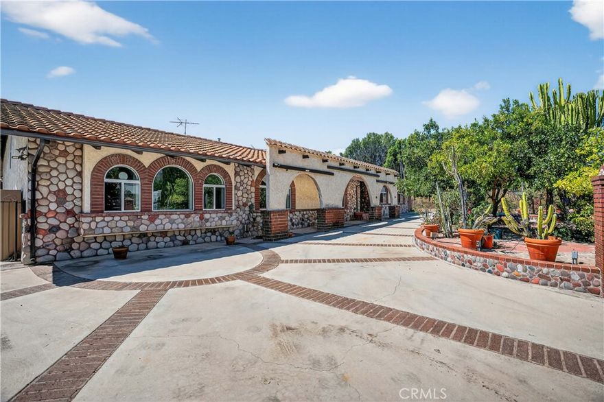 Welcome to “Old Granada Hills,” a neighborhood celebrated for its large parcels, orange orchards, and timeless charm. This is your golden opportunity to create a true family compound.

Set behind gates, this expansive 3,000+ sq. ft. home rests on a flat 18,700 sq. ft. lot with an impressive 110 feet of street frontage. A gracious circular driveway leads you inside where you’ll find 5 bedrooms and 4 bathrooms, including a massive primary suite with a wall of closets and spa tub.

The Chef’s kitchen is outfitted with a Viking oven, Wolf range, wood cabinetry, and abundant counter space. Multiple living and entertaining areas include a spacious living room, formal dining room, and an enormous bonus/game room—all enhanced by soaring wood ceilings, granite flooring, and oversized dual-pane windows. The cozy family room, complete with a wood-burning stone fireplace, opens to the covered patio and sparkling pool. Every bathroom is luxuriously finished in granite from top to bottom.

And the pool—OMG! Unlike most residential pools, this one is fully tiled from edge to floor. Black-tile swim lanes line the bottom, perfect for training or competition. After swimming, relax in the tiled spa or lounge on the shaded covered patio.

Beyond the pool lies a lighted tennis court, ideal for tennis, basketball, or even pickleball. The property also offers space for an RV, potential ADU, and a three-car garage with central I-beam—a dream setup for any craftsman or mechanic.

With the 405, 5, and 118 freeways, CSUN, Trader Joe’s, and Porter Ranch shopping and dining just minutes away, the location couldn’t be more convenient.

Yes, the home could use some TLC—fresh paint, new carpet in a few bedrooms, and light updates would make it shine again. But replicating these incredible improvements today would cost a fortune. After more than 60 years in the same family, this special property is ready for its next chapter.

Offered As-Is by the seller’s trust. What you see is what you get—the chance to build sweat equity and own a one-of-a-kind Granada Hills estate.
