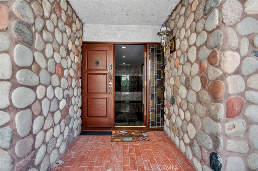 Price Improved! Welcome to “Old Granada Hills,” a neighborhood celebrated for its large parcels, orange orchards, and timeless charm. This is your golden opportunity to create a true family compound. Set behind gates, this expansive 3,000+ sq. ft. home rests on a flat 18,700 sq. ft. lot with an impressive 110 feet of street frontage. A gracious circular driveway leads you inside where you’ll find 5 bedrooms and 4 bathrooms, including a massive primary suite with a wall of closets and spa tub. The Chef’s kitchen is outfitted with a Viking oven, Wolf range, wood cabinetry, and abundant counter space. Multiple living and entertaining areas include a spacious living room, formal dining room, and an enormous bonus/game room—all enhanced by soaring wood ceilings, granite flooring, and oversized dual-pane windows. The cozy family room, complete with a wood-burning stone fireplace, opens to the covered patio and sparkling pool. Every bathroom is luxuriously finished in granite from top to bottom. And the pool—OMG! Unlike most residential pools, this one is fully tiled from edge to floor. Black-tile swim lanes line the bottom, perfect for training or competition. After swimming, relax in the tiled spa or lounge on the shaded covered patio. Beyond the pool lies a lighted tennis court, ideal for tennis, basketball, or even pickleball. The property also offers space for an RV, potential ADU, and a three-car garage with central I-beam—a dream setup for any craftsman or mechanic. With the 405, 5, and 118 freeways, CSUN, Trader Joe’s, and Porter Ranch shopping and dining just minutes away, the location couldn’t be more convenient. Freshly painted on the interior, it's clean and move-in-ready, Replicating these incredible improvements today would cost a fortune. After more than 60 years in the same family, this special property is ready for its next chapter. Offered As-Is by the seller’s trust. What you see is what you get—the chance to own a one-of-a-kind Granada Hills estate.