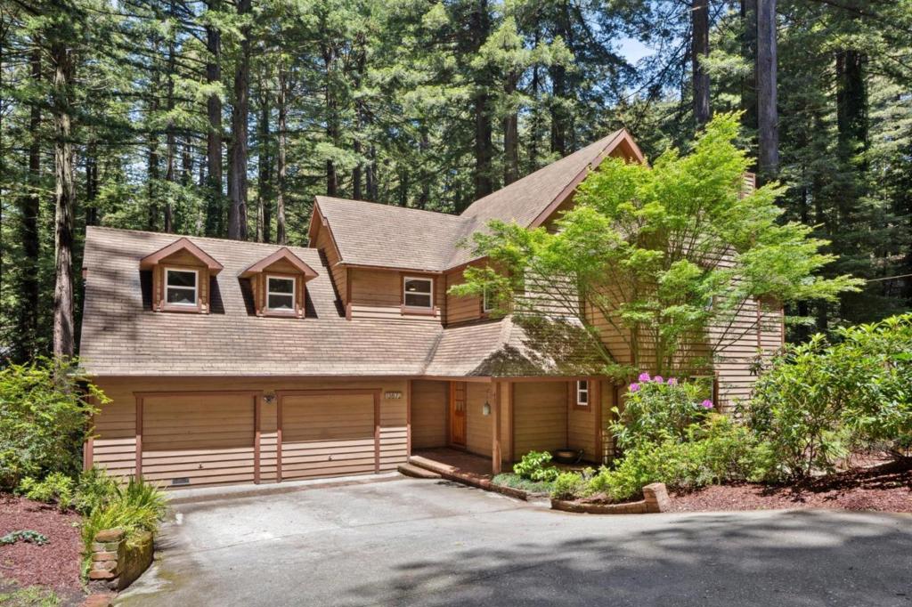 Spanning 2,670 square feet of living space, this home envelopes you with warmth and charm from the moment you enter. Sunlight filters through towering redwoods, creating a serene atmosphere throughout. Refinished hardwood floors and thoughtful modern updates blend timeless quality with everyday comfort. The spacious floor plan flows seamlessly, ideal for both daily living and entertaining. The main floor features a gourmet kitchen with high-end appliances, sleek finishes, dining area, family room and dedicated home office offers the perfect space for remote work or creative pursuits. Upstairs, the bedrooms provide privacy and tranquility. A large, bright family room stands out as a favorite space, filled with natural light and a cozy, welcoming ambiance. Multiple large decks extend the living space outdoors, offering peaceful spots for relaxing, entertaining, or enjoying the majestic redwood surroundings. Additional features include a wine cellar and ample storage. Tucked just off the scenic Skyline Corridor with easy access to Hwy 92, 280/101, SFO, open space trails, restaurants, and award-winning Kings Mtn Elementary, this home offers a rare blend of privacy, convenience, and a strong sense of community fostered by friendly neighbors and the Kings Mtn Volunteer Art Fair.