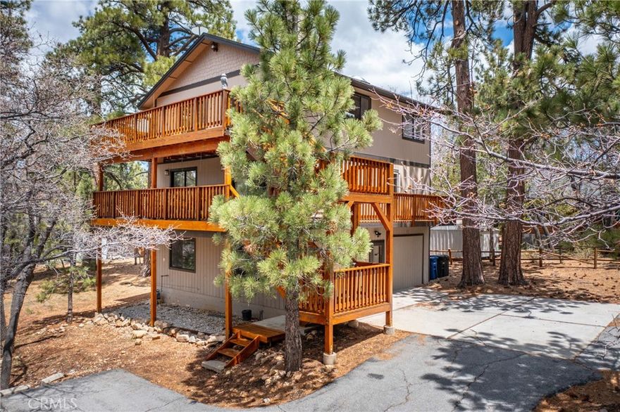 Welcome to 1772 Columbine Drive! Situated at the top of  the prestigious Moonridge Mountain Estates. One of the highest elevated homes in the area providing you with spectacular mountain, ski resort and valley views!! Words do not do this home justice as you will need to schedule an appointment to view it for yourself!! This home was built in 1984 and features 2031 square feet of living space. It sits on an impressive 9598 square foot lot with gorgeous trees that surround the home bringing nature to your doorstep!! As you enter through the first floor entry, you will find a spacious Family Room and/or Bedroom and the adjoining room would be a great Game Room. This area good possibly permitted for an ADU conversion that would be a great short or long term rental with its own separate entry. As we make our way up to the second level you will find tow large bedrooms, one full bathroom and one 3/4 bathroom with the Laundry Area in one of the bathrooms. Both bedrooms have sliding glass doors to the outside where you will have a wrap around deck for you to enjoy your morning coffee or evening glass of wine. This is also a second entry point with a Mud Room. From here we can go up to the third level where you will fall in love with the open Living Room/Family Room. There is a custom built split level Wood Burning Stove. This unique piece not only accentuates the room but gives warmth on those cold snowy nights. The knotty pine ceilings and two skylights in this area bring nature indoors as wells as lots of natural light. The Kitchen and Dining Room boost hand rubbed cherry wood flooring and the classic wood cabinetry giving you that cozy mountain feel. There are two separate sliders to the outside deck with AHH inspiring views of bear Mountain, the ski run Geronimo at an elevation of 8800 feet as well as valley views, the crystal blue skies during the day and the milky way at night. This level also features a 1/2 bathroom for added convenience. Additional features include weatherized exterior decking and stairs. Central Heating and an upgraded Water Heater. Long driveway leads you to ample parking spaces for several vehicles including an RV and or Boat and a Storage Shed is included. This location gives you the space and tranquility yet it is just a few minutes away to all of Big Bear. Lets schedule a showing with your Realtor and I hope to see you in Escrow!! : )