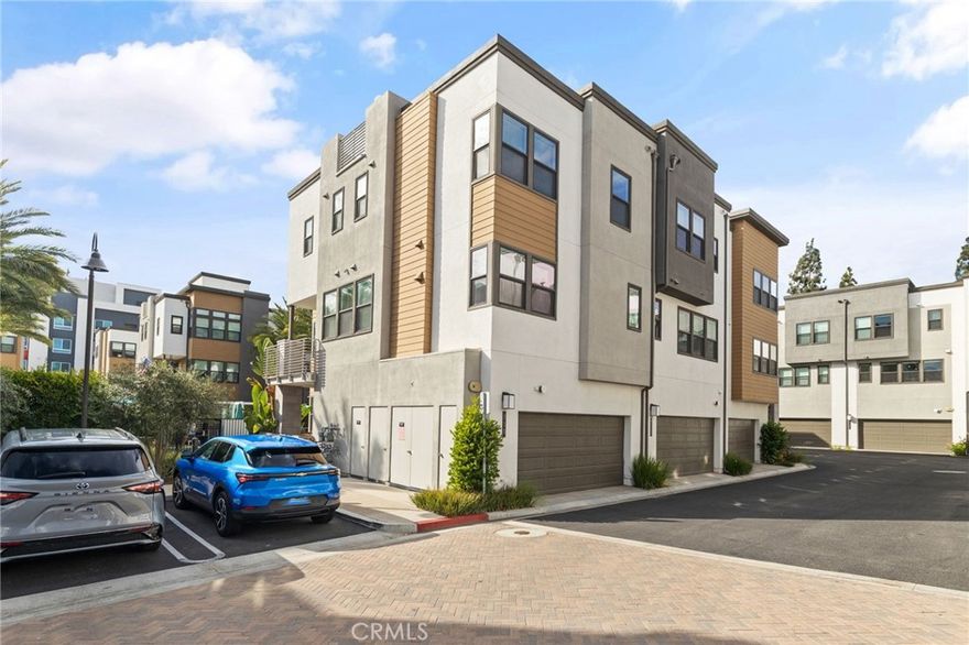 Experience modern luxury at 712 South Grable Circle, a professionally upgraded townhome in ParkerOne, a sought-after TRI Pointe Homes community in Orange. Built in 2021, this stunning residence showcases designer finishes throughout, including European Alabascato Dashwood hardwood flooring, Hunter Douglas Provenance woven shades, and a gourmet kitchen with quartz countertops, custom color upgraded shaker style cabinetry, a full herringbone subway tile backsplash, and a dramatic quartz waterfall-edge island. The bathrooms are beautifully upgraded with quartz countertops, framed mirrors, 6-inch backsplashes, and 3/8-inch glass shower enclosures. For a complete list of builders' upgrades please contact the listing agent. Enter through a charming covered porch and foyer to find a main-level office and powder room perfect for a home office or conducting business from home. The second level features an open-concept living area with a chef-inspired kitchen, walk-in pantry, guest powder room, and access to a spacious outdoor deck ideal for relaxing or entertaining. On the third level, the primary suite offers a walk-in closet, dual vanities, and a luxurious stand-up shower adorned with builder-quality upgrades. The secondary bedroom suite includes a soaking tub and its own private bath. A spacious laundry room is conveniently located on this level as well. Additional highlights include paid solar, sleek modern chandeliers, recessed LED lighting throughout, tankless water heater and dedicated EV charger circuit in the garage. The home enjoys a private interior location just steps from the community pool and cabanas. Beyond your doorstep, enjoy close proximity to CHOC and St. Joseph Hospital, Chapman University, and Old Towne Orange offering an unmatched blend of luxury, comfort, and convenience. Minutes away from four major freeways the 22, 57, 5, and 55. Schedule your private tour today!