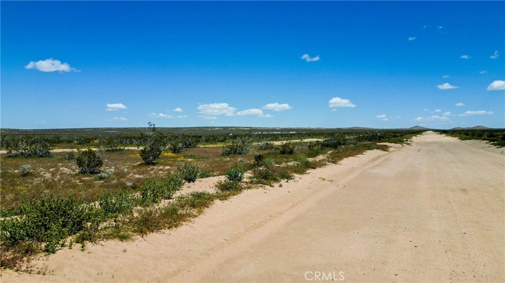 Own 2.55 acres of high desert opportunity in Hi Vista for just $7,500 with seller financing available. This flat, buildable parcel sits 21.4 miles from Edwards Air Force Base in the booming Antelope Valley where aerospace jobs and infrastructure investment are driving rapid growth. The property offers panoramic mountain views, well-draining desert soil perfect for construction, and agricultural zoning allowing residential development, horses, recreation, and investment uses. Located 13 miles from Saddleback Butte State Park. The 333x334 lot provides excellent building potential on stable desert terrain with minimal fire risk. While utilities require development, the area's expanding infrastructure and proximity to major employment centers make this an exceptional investment. The Antelope Valley's 3% annual population growth, $502K average home prices, and billion-dollar development projects create strong appreciation potential. Perfect for off-grid living, weekend retreat, horse property, or long-term investment in California's fastest-growing desert region. Access via dirt road approximately 650 feet from E Avenue C. Don't miss this chance to own affordable acreage in the path of growth.