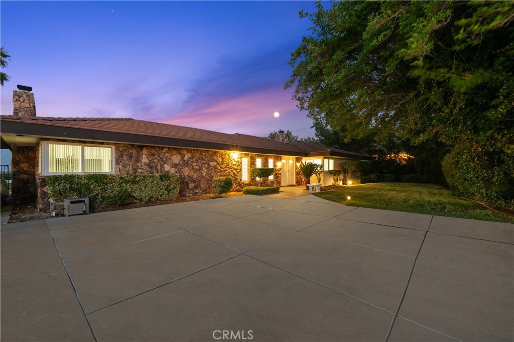 Welcome to 354 Westlake Dr in the sought-after Ana Verde Hills of Palmdale. This remodeled single-story home offers nearly 4,300 sq. ft. of living space on over an acre of flat land. Originally built in 1963 and updated in 2007, the property features 5 bedrooms (including a workout room or optional 5th bedroom), 3 bathrooms, and an open-concept layout with a gourmet kitchen, grand living room with a rock fireplace, recessed lighting, and stunning views of Palmdale Lake, city lights, and the surrounding mountains. One bedroom offers private access to a separate patio, perfect for guests or a quiet retreat. The master suite includes a spa-inspired bath and direct access to the garden. Additional highlights include an oversized 3-car detached garage, 2-car carport, all-electric utilities, city water, and abundant parking for RVs, toys, and extra vehicles. Conveniently located near the 14 Freeway, this is a rare opportunity to own a spacious, updated home with incredible views in a peaceful setting.