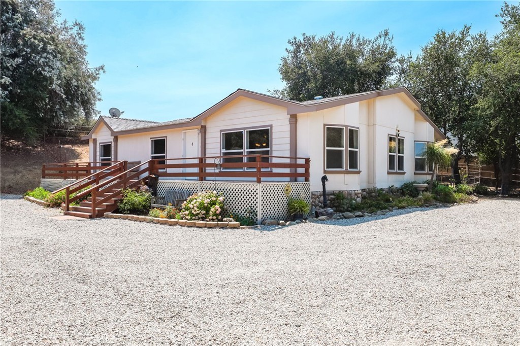 PERFECT STARTER HOME IN GORGEOUS RANCHO CARRILLO! This spacious, light filled home welcomes you in with new Luxury Vinyl Plank floors throughout, inviting you into the freshly painted space that features minimum 10 ft ceilings and an open plan layout. A large living or bonus room opens up as you step through the door, and leads you into the generous family kitchen, with a breakfast bar as well as breakfast nook. Friends and guests can enjoy your company while you cook by pulling up a stool at the kitchen island bar, or join in with the rest of the family in the open family room, complete with cozy fireplace for those cooler nights. A lovely dining room awaits the family, or take the moment outside and dine alfresco on the large deck. At the end of the day, your principal bedroom awaits, complete with spacious principal bathroom. Two more beds & a hall bath means everyone is fully cared for. Serene Oak trees grace the land, where there is plenty of opportunity to house your animals, grow veggies, or just enjoy the peace and privacy. Rancho Carrillo is Country Living/City Close destination, only 15 minutes to shopping & dining and a few minutes more to beaches, entertainment, and all that Orange County is famous for. This is the One to call Home!