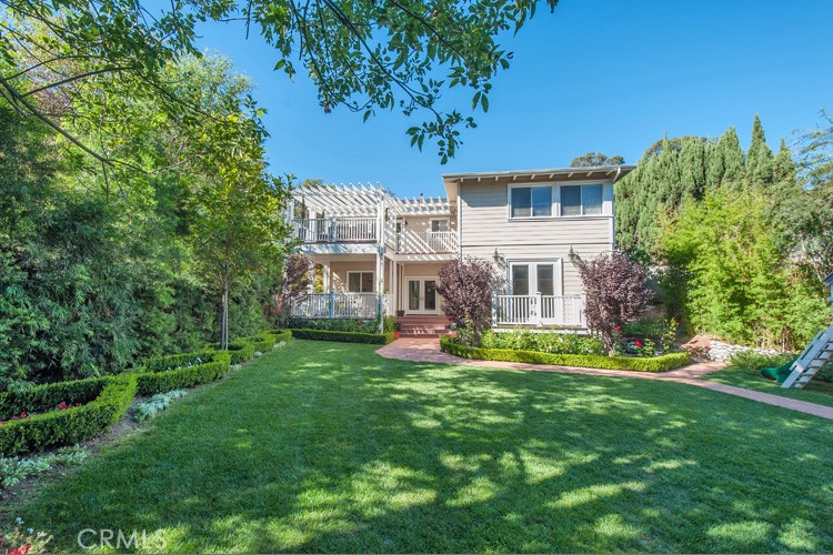 Experience tranquil living in this beautifully updated home that perfectly blends style and comfort. Step inside to discover recessed lighting, hardwood floors, and distinctive custom tile work. The kitchen is a chef's dream with handmade Italian tiles, a Thermador cooktop, a wall-mounted pot filler, and a warming drawer. The bright and airy living and dining areas boast vaulted ceilings and skylights, seamlessly connecting to one of two expansive decks—perfect for outdoor dining and entertaining. The HGTV-styled master suite offers coved ceilings, custom closets, and a master bath designed with care.
This home includes a two-car garage and ample street and off-street parking. With dual HVAC, Pella windows and doors, and a tankless water heater, comfort is guaranteed year-round. Nestled on a quiet street off Mulholland, the property enjoys a peaceful setting with a large, flat grassy backyard. Living atop the hill grants easy access to the dynamic Hollywood area, Studio City, and Toluca Lake, delivering the best of both worlds. Conveniently located near Valley View Elementary (tenants should verify availability).