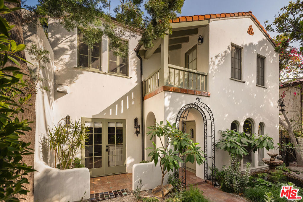 Elegant design, luxurious finishes, and sweeping views define this 1926 Spanish Colonial in one of Los Feliz's most sought-after enclaves. The home has been meticulously designed, and all systems have been upgraded over the past two years. Upon entering, you are greeted by a living room that exudes warmth and grandeur with arched windows, coved ceilings, Italian Murano sconces, and a classic fireplace. A chef's kitchen with Wolf appliances, stone counters, and Waterworks fixtures flows into a window-lined dining room overlooking the backyard and skyline. With five bedrooms and four bathrooms, the home offers abundant space and flexibility. Each upstairs suite includes an en suite bath and opens to private sunlit decks with Zia marble tile and views of the Griffith Observatory and surrounding hills. The lower level offers a screening room, den, two guest suites and a cedar sauna. The extraordinary outdoor living spaces were crafted by AD100 landscape designers Terremoto, featuring native plantings, gardens, fruit trees, redwood decking, cedar jacuzzi, and custom fencing. Located just moments from local favorites on Vermont and Hillhurst and steps from the scenic trails of Griffith Park. This timeless turnkey Los Feliz home is a rare blend of architectural heritage and modern luxury.
