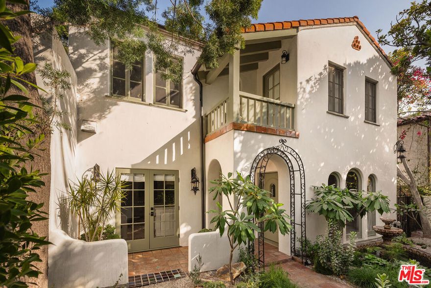 Elegant design, luxurious finishes, and sweeping views define this 1926 Spanish Colonial in one of Los Feliz's most sought-after enclaves. The home has been meticulously designed, and all systems have been upgraded over the past two years. Upon entering, you are greeted by a living room that exudes warmth and grandeur with arched windows, coved ceilings, Italian Murano sconces, and a classic fireplace. A chef's kitchen with Wolf appliances, stone counters, and Waterworks fixtures flows into a window-lined dining room overlooking the backyard and skyline. With five bedrooms and four bathrooms, the home offers abundant space and flexibility. Each upstairs suite includes an en suite bath and opens to private sunlit decks with Zia marble tile and views of the Griffith Observatory and surrounding hills. The lower level offers a screening room, den, two guest suites and a cedar sauna. The extraordinary outdoor living spaces were crafted by AD100 landscape designers Terremoto, featuring native plantings, gardens, fruit trees, redwood decking, cedar jacuzzi, and custom fencing. Located just moments from local favorites on Vermont and Hillhurst and steps from the scenic trails of Griffith Park. This timeless turnkey Los Feliz home is a rare blend of architectural heritage and modern luxury.