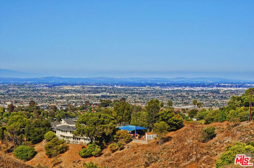 Tucked away in peaceful seclusion, this uniquely unassuming home is a true sanctuary offering panoramic views of the city skyline, distant mountains, and sparkling coastline. Thoughtfully updated and masterfully designed, every detail of the home is crafted to maximize the natural beauty of its surroundings while preserving a sense of privacy and effortless indoor-outdoor living. Light, airy, and functionally elegant, the home's open floor plan flows gracefully from one space to the next. The kitchen, complete with a cozy breakfast nook, overlooks city views and opens seamlessly into a formal dining room and an expansive family room. Entertain with ease at the built-in wet bar, or showcase your collection in the walk-in wine refrigerator. Oversized sliding glass doors lead to a one-of-a-kind backyard oasis that must be experienced to be fully appreciated. A wide and welcoming hallway leads to the bedroom wing, where the primary suite serves as a peaceful retreat. Featuring dual walk-in closets, a private bath, and breathtaking views, it's the perfect blend of comfort and luxury. Outdoors, the huge backyard is a haven for relaxation and entertaining. Multiple seating areas provide intimate spaces for conversation around the fire pits or beside a striking stone fireplace, all set against sweeping vistas. A shaded pergola with a mounted big screen TV invites guests to gather and unwind in comfort. The built-in BBQ is perfectly placed so the host can stay in the heart of the action while taking in views of Kings Harbor. A charming rustic bar, custom cornhole court and lush, thoughtfully curated landscaping complete this incredible space. Even the garage is masterfully designed and organizeda true extension of the home's thoughtful craftsmanship. Built-in custom cabinetry lines the walls, offering plentiful storage without clutter. Durable epoxy floors lend a clean, polished finish, while a dedicated laundry area has been seamlessly integrated for optimal function and flow. It's as practical as it is refined. This hidden gem is more than a homeit's a lifestyle, offering serenity, beauty, and connection in one extraordinary package.