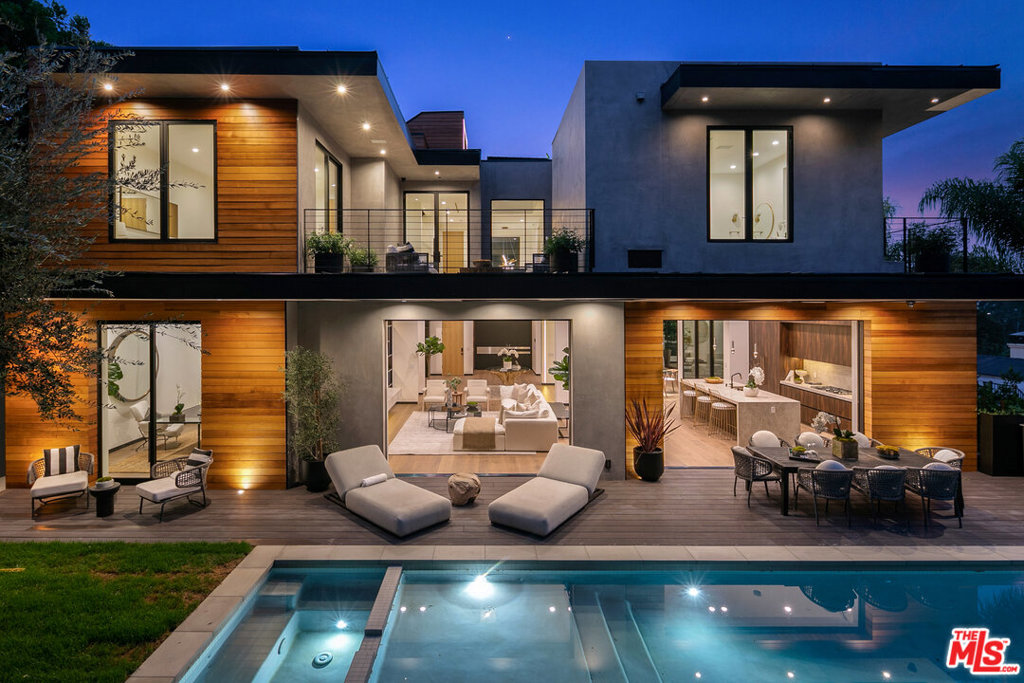 Designed by NYB Designs & built by PERS Development, this ultra-Private Organic Contemporary, clad with fine Cedar Wood and concrete form board, is surrounded by dozens of 50-yr olive trees w/ epic city views on a vast, ultra large lot on famed Rising Glen. Brand new construction, sparing no detail. Reminiscent of the Soho House, with incredible scale, and flooded with an abundance of natural light. You are welcomed to a double height massive custom pivot door, unto gracious foyer. Disappearing walls of glass to grassy backyard, pool area, with Full BBQ/ Outdoor Kitchen and smart wiring throughout. Spanning over 5,700 FT above ground, 4 sumptuous bedrooms, all with en suite baths. 1,500 SQFT Master wing set against staggering city skyline. Massive rooftop deck, with wrap around 360- degree views. Enormous garage, with ample space for lifts, and additional off street parking. An architectural feat long in the making, ready for the most discerning buyer.