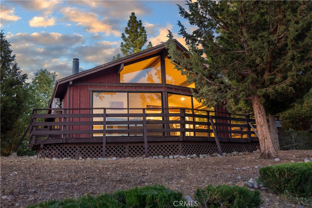 Nestled in the heart of beautiful Big Bear City, 1270 Sheephorn Road is a charming cabin that captures the essence of mountain living. This delightful home features 2 cozy bedrooms and 1.5 bathrooms, spanning a generous 1,170 square feet. The cabin's interior is highlighted by vaulted wood ceilings that add an airy and rustic charm, while the granite countertops in the kitchen provide a modern touch. The living room is adorned with large sliding doors that flood the space with natural light and offer breathtaking views of the surrounding landscape. Step outside onto the wrap-around deck to immerse yourself in the wonderful setting, perfect for relaxation or entertaining guests with great views! Situated on an expansive 8,075 square foot lot, this property not only offers ample outdoor space but also a large backyard storage shed, ideal for all your storage needs. The large lot enhances the cabin's appeal, providing a sense of privacy and tranquility. Located in a great neighborhood, this home offers an idyllic retreat with the convenience of nearby amenities. Whether you're looking for a permanent residence or a vacation getaway, this cabin's combination of charm and a peaceful setting make it an exceptional choice for those seeking the quintessential mountain lifestyle. Experience the serenity and beauty of Big Bear at its finest!