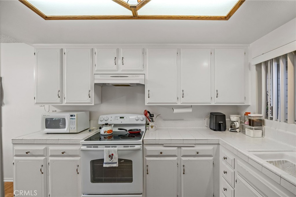 Welcome to this charming 2-bedroom, 2-bath condo nestled in the heart of the highly sought-after Laguna Woods Village—one of the most recreation-rich 55+ communities in the country. This 1,123 sq ft corner unit is ideally positioned with no one below and conveniently located above the carport, offering added privacy and ease of access. Step inside to find a light and bright interior, featuring a fresh white kitchen that opens into the spacious living area. The enclosed balcony provides a peaceful retreat for enjoying morning coffee, reading, or simply soaking in the sunshine. Residents of Laguna Woods Village enjoy resort-style amenities designed to invigorate the body, mind, and spirit, including two professional golf courses, 10 tennis courts, seven pickleball courts, five pools, four hot pools, three fitness centers, an equestrian center, and more than 200 clubs and social groups to join. Don’t miss your opportunity to live in this vibrant, active community—where every day can feel like a vacation!