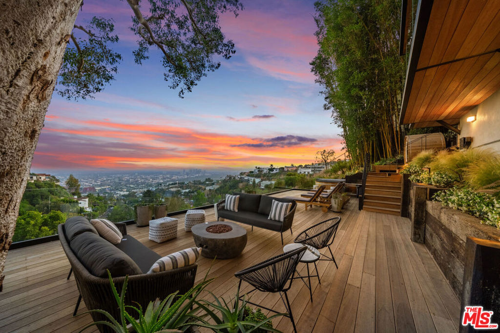 Newly remodeled down to the studs, this warm and modern zen retreat offers panoramic city views and wellness-focused amenities throughout. Step into this striking 4-bedroom, 4.5-bath contemporary masterpiece nestled in the heart of the Hollywood Hills where sleek design, serene living, and breathtaking vistas span across four thoughtfully designed levels. Wrapped in floor-to-ceiling glass, the home captures LA's skyline from nearly every room. Enjoy a private sauna, cold plunge, jacuzzi, and an outdoor kitchen complete with BBQ and pizza oven ideal for entertaining or recharging in style. Each floor offers thoughtfully designed spaces, combining privacy and elegance throughout. Every bedroom features its own en-suite bathroom, and the interiors boast sophisticated finishes and a serene ambiance. A secure 2-car garage ensures easy parking and added peace of mind. This home is a true retreat above the city designed for guests who crave beauty, comfort, and a front-row seat to the magic of Los Angeles. Coming soon: a private theater room and gym perfect for elevated living and entertainment.