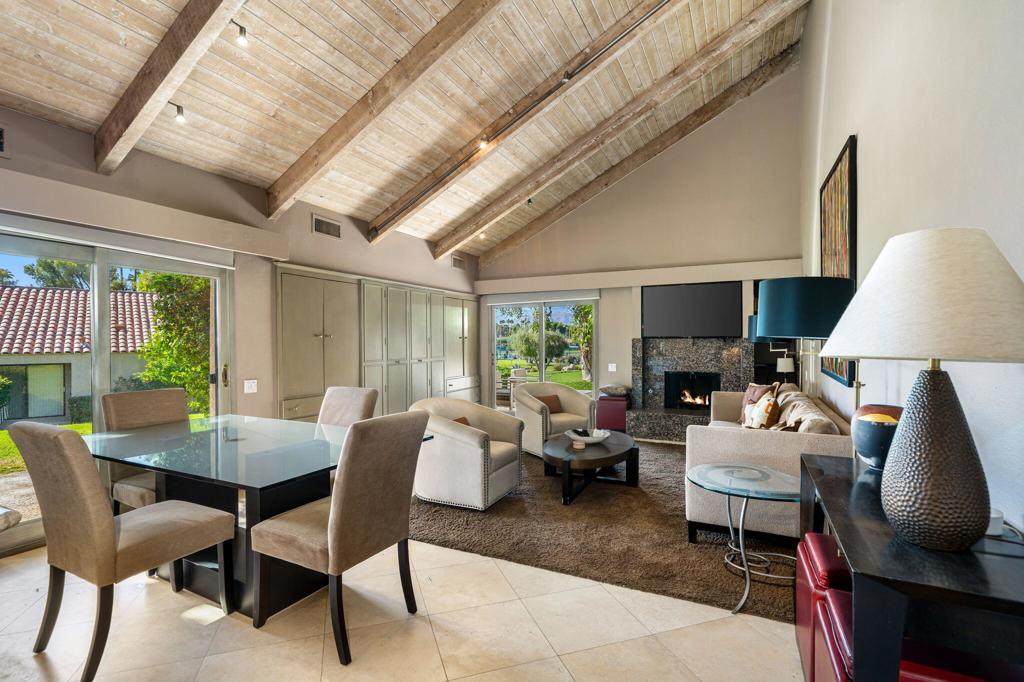 Welcome to this beautifully maintained, turnkey-furnished one-bedroom Tennis Villa, ideally located inside prestigious Mission Hills Country Club. Perfectly positioned to capture stunning mountain views, this charming residence offers a warm and inviting interior featuring soaring wood-beamed ceilings, custom flooring, upgraded lighting, and double-pane sliding glass doors that fill the space with natural light. The well-appointed kitchen includes granite countertops and stainless-steel appliances, overlooking a spacious Great Room with a decorative fireplace--ideal for relaxing or entertaining. The generous primary suite provides a peaceful retreat with a built-in desk/entertainment center and an updated en-suite bathroom boasting dual vanities and an oversized walk-in shower. Whether you're seeking a full-time residence, vacation getaway, or investment property, this villa delivers exceptional comfort and style. Mission Hills Country Club offers a variety of membership options for tennis and golf enthusiasts, with world-class amenities including three championship golf courses, 30 tennis courts (grass, clay, and hard), pickleball and croquet courts, a state-of-the-art fitness center, spa services, and a vibrant calendar of dining and social events--all within one of Rancho Mirage's most sought-after communities.
