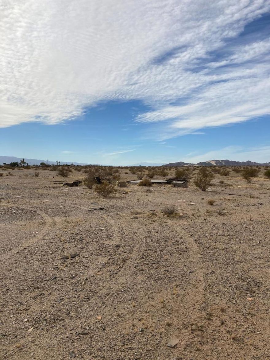 Wide open spaces, starry nights. Wonder Valley - gearing up to be the next Joshua Tree getaway. Solitude and peace abounds.  5 flat useable acres. Utilities appear to be nearby, slab on property from prior Homestead structure. Roads are in great condition leading to property. Panoramic views.