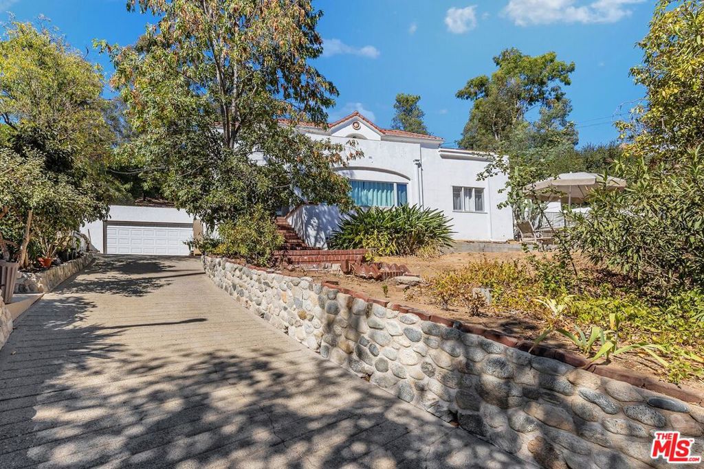 DEVELOPER & BUILDERS OPPORTUNITY! Huge lot with 34,655 sq. ft. Discover your new lifestyle in this two-story home situated on a fabulous neighborhood in Eagle Rock. Beyond the verdant trees is a Traditional combined with modern style retreat from the city. Upon entry, you are greeted by warmth and inviting foyer. Enjoy gatherings in the generously-sized living room and formal dining room that opens to the backyard. Renovated kitchen with quartz countertops, tile flooring, stainless steel appliances, built-in oven, farmhouse sink and beautiful custom white lacquer cabinets. The first floor offers a primary bedroom with ensuite shower, 2 additional bedrooms and full bathroom in the hallway with double vanity & soak in tub. Laundry room is conveniently located on the main floor. On the upper level, a ballroom awaits where you can entertain in grand style featuring French doors that open to the wraparound balcony where you can enjoy the views. Hardwood floor and natural light abound throughout the space. Additional 2nd ensuite consists of tastefully designed full bath with marble walls, floors and vanity. Another spacious bedroom and a full bath with separate soaking tub and shower on this floor. Minutes to the vibrant downtown Eaglerock where trendy restaurants, vintage shops and thriving arts scenes along Colorado Blvd. Close proximity to schools, Downtown Los Angeles (Dodger Stadium), Glendale (Americana at Brand) and Pasadena (Rose Bowl). Come and check out this Eclectic Vibe community.