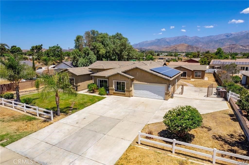 This ranch style home sits on a Huge lot with mountain and hills views and will WOW you from the moment you set eyes on it . With ample driveway parking, 3 car tandem garage, Homes **NEW Interior Paint** NEW Laminate Flooring ** NEW Baseboard** NEW Quartz Countertops** NEW Stainless-steel appliances** and **NEW kitchen sign**.. Home feature , 5 bedrooms 3 1/2 baths with one Jack and Jill bathroom, Master Bedroom boasts a large bathroom with dual sinks, dressing table, walk-in shower, Jacuzzi tub, and walk-in closet. The living areas are spacious, with a formal living/dining area to greet you upon entry, then opening to the huge kitchen which opens to the family room.Has Laundry room with storage cabinet.. The kitchen has been remodeled with New Quartz counters, New Stainless-Steel appliances and an enormous island with bar seating. Perfect for family gatherings and entertaining! From the family room oversized sliding glass doors allow an abundance of light to filter in and give access to the wide back patio... **SOLAR PANELS** close to freeway