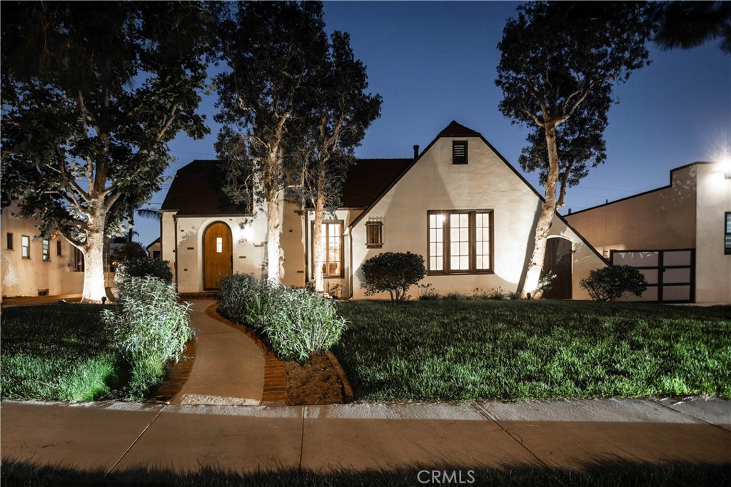 Wonderful opportunity to own a beautiful Tudor home in Rossmoyne area of Glendale. Loaded with curb appeal and originality. Step into the impressive living room through the original wooden arched door to its high ceiling, built-in bookcases, and gleaming hardwood floors throughout. Arch opening to formal dining room for wonderful dinners and entertainment. The cook's kitchen with its tiled countertops has new stainless steel appliances and large breakfast area. The primary bedroom suite has built-in illuminated fireplace, television, etc. The primary bath has double vanity sinks with tiled counters, tub with shower and large walk-in closet. Accessible from the primary suite is the lovely pavered patio and stone yard. Very delightful, peaceful and serene with its fountain and twinkling lites at night. You can entertain in this yard also with barbecue. Down the hall is another full bath, beautiful floor and tub with shower. The second bedroom has wood wainscoting and is currently used as office. The third bedroom is light and bright also with gleaming hardwood floors. The original wood of all of the doors make this home very impressive. From the front of the house you have a lovely mountain view. There is a wide driveway, 2 car garage with workshop bench. Also has a newer roof on this home. Beautifully landscaped. Conveniently located to Glendale schools, freeway, Nibley Park and shopping which includes Vons, Whole Foods, Trader Joe's and the new soon Erewhon Market. You wil be quite impressed with this home on lovely tree lined street.
