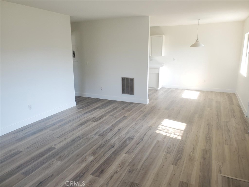 Fantastic all new gray/tan wood plank floors, new baseboards, new scraped ceilings, new bathroom vanity, new Shaker style kitchen cabinets, new quartz countertops in kitchen and bathroom, new faucets, new door hardware, new stylish interior doors and new light fixtures. This place looks like a model on the inside. The kitchen opens to a nice dining area and a huge living room. The master bedroom is also massive (large enough for a full office in bedroom). A shared two car garage ( you get one side) with a very large private and lockable storage room.