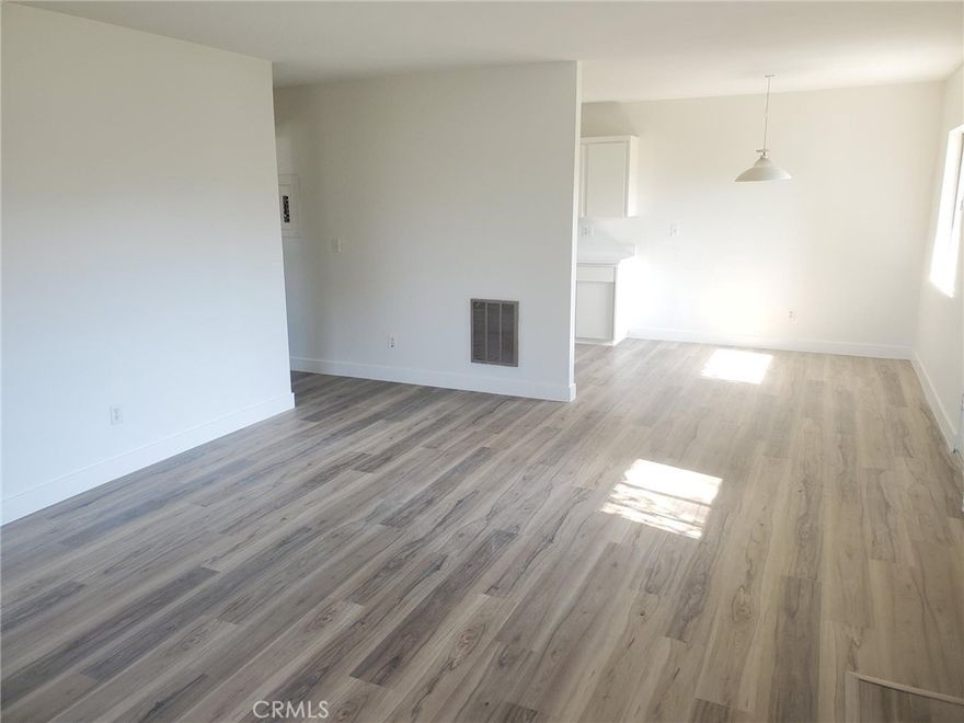 Fantastic all new gray/tan wood plank floors, new baseboards, new scraped ceilings, new bathroom vanity, new Shaker style kitchen cabinets, new quartz countertops in kitchen and bathroom, new faucets, new door hardware, new stylish interior doors and new light fixtures.  This place looks like a model on the inside.  The kitchen opens to a nice dining area and a huge living room.  The master bedroom is also massive (large enough for a full office in bedroom).  A shared two car garage ( you get one side) with a very large private and lockable storage room.