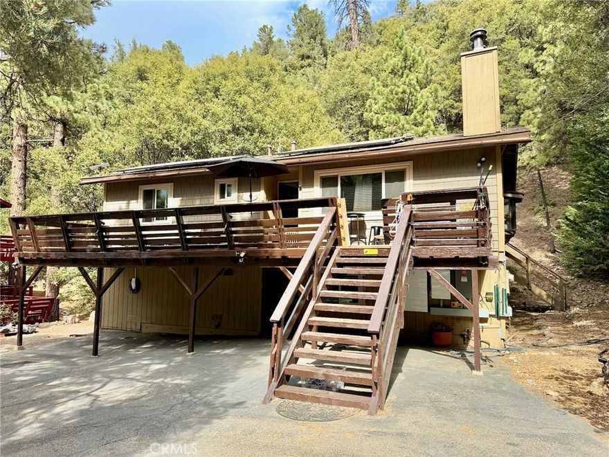 Welcome to this beautifully remodeled 3 bedroom, 2 bath view home offering over 1,800 sq. ft. of living space on an almost ¼ acre private lot. Perfectly situated at the end of a quiet cul-de-sac, this property is just steps from the popular Waterfall Trailhead.

The open floor plan features a warm and inviting family room with a wood-burning fireplace set in a raised stone hearth, along with a cozy wood-burning stove in the downstairs primary bedroom. The remodeled kitchen boasts new granite counters, a travertine backsplash, and plenty of space for entertaining. Gorgeous new hickory flooring flows through the upstairs and much of the downstairs, enhancing the home’s rustic charm.

Additional highlights include a large gym and storage room with a private outside entrance, spacious decks in both the front and rear for enjoying the fresh mountain air, a circular driveway with plenty of off-street parking, and a leased solar system for energy efficiency.

This home blends comfort, style, and location—don’t miss the chance to make it yours!