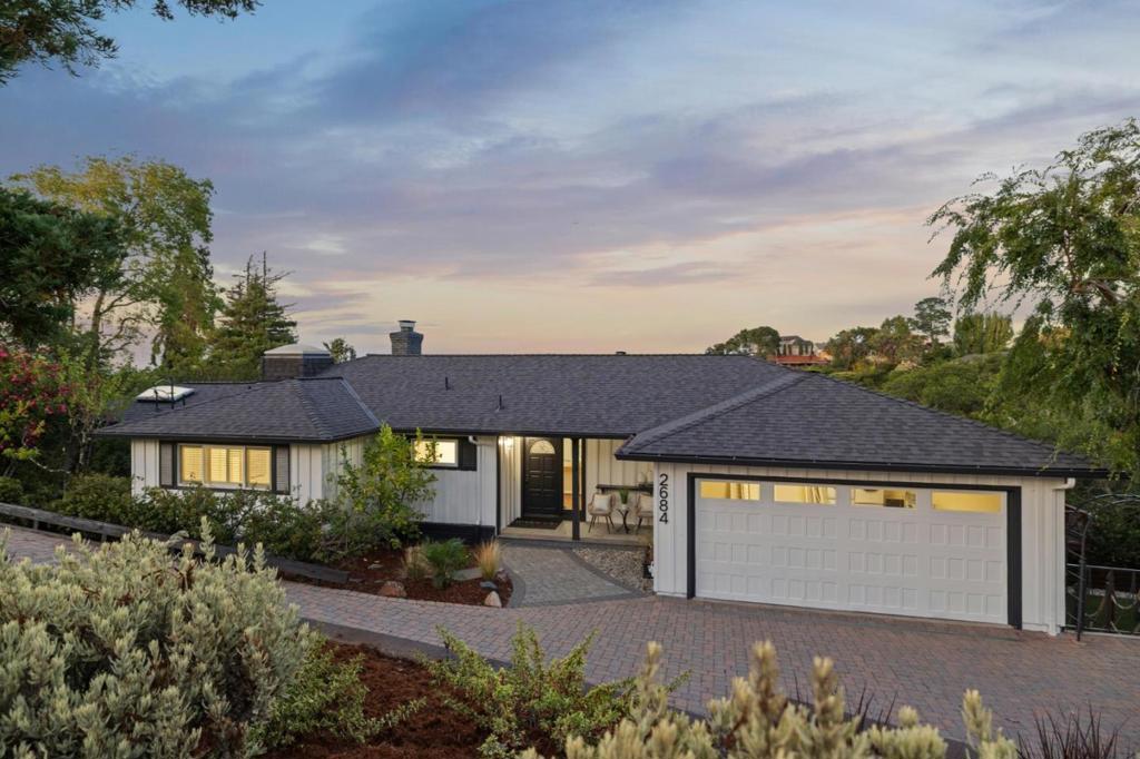 Welcome to 2684 Summit Dr-3,089 sq ft of refined living with stunning views throughout, located in one of Burlingame's most desirable neighborhoods. This elegant two-level home offers 4 spacious bedrooms and 4 full bathrooms, blending timeless charm with modern comfort. The main level features a bright living room, formal dining area, and a chef-inspired kitchen with high-end finishes, an eat-in nook, and seamless flow for entertaining. Two bedrooms, including a luxurious primary suite with sweeping Bay views, and two full baths complete the main floor. Downstairs, a versatile flex space provides options for a family room, home office, or home gym perfect for today's lifestyle. Two additional bedrooms and two full baths offer privacy and comfort for guests or family. Step outside to an expansive backyard with a large deck, panoramic Bay views, and a hot tub-ideal for outdoor living and entertaining. Additional highlights include a two-car garage, oversized driveway with guest parking, and ample storage. Just minutes from downtown Burlingame, top-rated schools, dining, shopping, and commuter routes. This is a rare opportunity to own a home that perfectly balances elegance, comfort, and location.