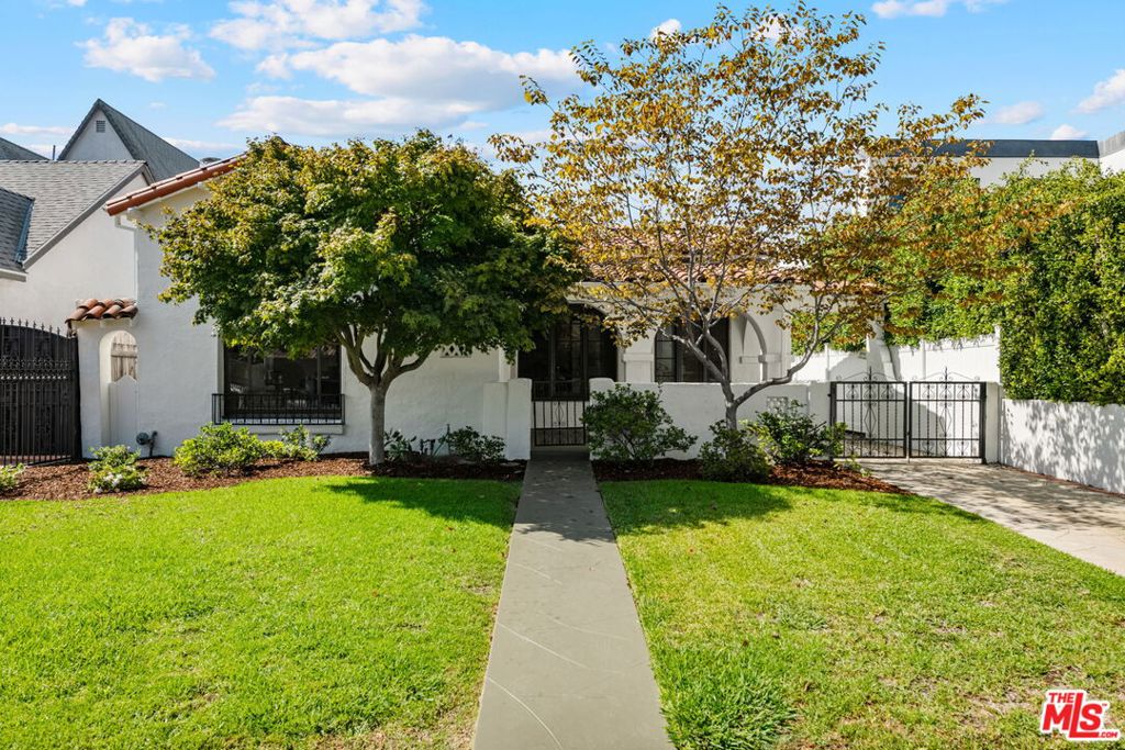 Exceptional Mint Condition 3 bed/2 bath Spanish with meticulous original unspoiled finishes and character. So unique to find a gem like this one. Charming arched covered porch to entry area with closet, entering into living room with vaulted ceiling and original stenciled wood beams, tiled fireplace with wood mantle, sconce lighting and oversized wood-framed picture window filling home with incredible natural light. Dining room with tray ceiling feature opens to sunny breakfast room with built-ins. Light and bright kitchen with authentic tiled countertops and vintage pale pink Wedgewood range/oven as the centerpiece. Separate laundry room with side door access to backyard. 3 spacious bedrooms including primary bedroom with French door to large backyard with majestic mature tree and garden in addition to detached garage. 3rd bedroom with attached 3/4 bath complete with original tiles. Full bath in hallway with separate bath and shower and with stunning vintage tile finishes. Additional features include all wood doors with original crystal doorknob hardware, hardwood flooring throughout, central ac/heat, wrought-iron gated driveway. Close proximity to Westwood Blvd. retail and restaurants, UCLA, Westfield Century City Mall and Beverly Hills. Westwood Charter School. Come be wowed by this special Spanish!