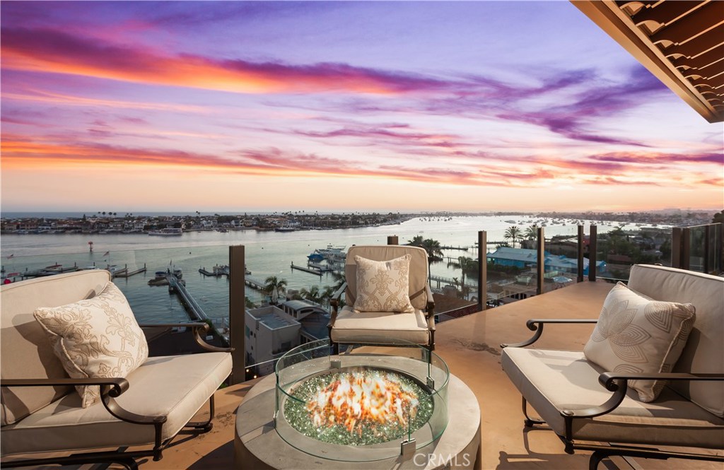 Experience the Crown Jewel of Corona del Mar
Positioned on the coveted front-row bluff of Pacific Drive, this extraordinary residence offers a rare opportunity to embrace the very best of coastal California living. Elevated above the famed California Riviera, the home commands sweeping, unobstructed vistas—spanning the Pacific Ocean, Catalina Island, vibrant sunsets, Newport Coast hills, yacht activity through Newport Harbor, the Balboa Peninsula, the Wedge, and city lights reaching to Palos Verdes and Los Angeles.
Timeless in design, the home’s Spanish Colonial-inspired architecture unfolds across 4,380 square feet of bright, open living space, featuring 4 bedrooms, 3.5 bathrooms, a media/bonus room, and a dedicated wellness studio. Over 1,500 square feet of terraces and patios span multiple levels, offering seamless indoor-outdoor living and ideal spaces for entertaining against a stunning coastal backdrop.The chef’s kitchen pairs form and function with limestone floors, concrete and Calacatta countertops, and top-tier appliances. The entire lower level is a private primary suite retreat—featuring commanding blufftop views, a spa-like bath wrapped in Calacatta stone, a generous walk-in closet, a flexible wellness room, and a newly installed spa overlooking the harbor.The upper level offers privacy and flexibility, perfect for guests or multigenerational living. Thoughtful upgrades include Tesla charging and curated lifestyle enhancements throughout. Ideally located within walking distance to Corona del Mar’s most beloved destinations—Beaches, Begonia Park, yacht clubs, Newport Beach Country Club, Fashion Island, village shops and restaurants—and just minutes from John Wayne Airport.
Live the dream on Pacific Drive—one of Corona del Mar’s most iconic and irreplaceable blufftop streets.