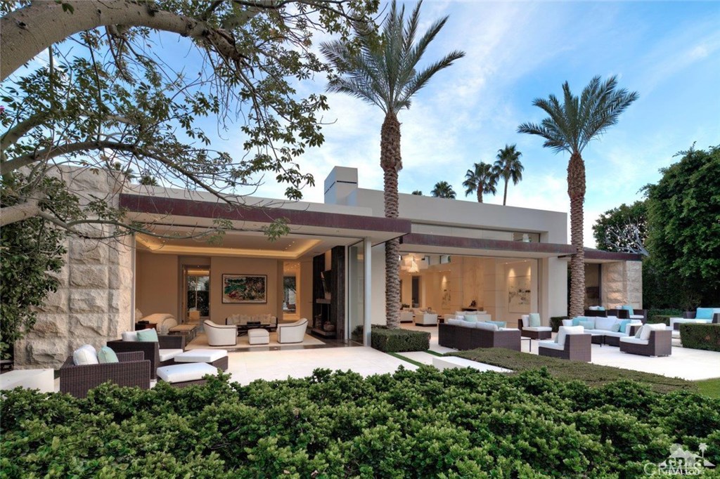 Perched above a grassy knoll, just beyond a serene lake, is this beacon of light beckoning you home from an amazing day of golf play among the moguls and traps of the Desert Course. In reflection of The Vintage Club's renaissance, architect Tim Morrison was granted the opportunity to reimagine the home's original design to elevate this residence into the 21st Century. The extensive remodel was completed in 2013 bringing its square footage to around 8,070 SF, creating new open spaces, solar energy and a smart home automation system culminating into this magnificent home being offered for sale. The home's floor plan encircles the interior courtyard with saltwater pool and spa along with dining and seating niches that welcome outdoor entertaining. Opposite the main house and near the gated entry is a detached one-bedroom Casita with breakfast bar and a private view patio.The rear elevation sits north minimizing the impact of the desert's afternoon sun.