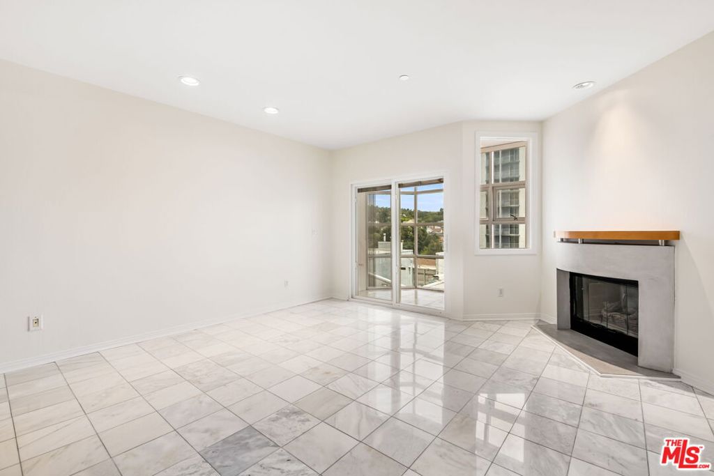 This private and well-appointed Brentwood townhouse offers serene city/mountain views and a thoughtfully designed, spacious layout. The upper level features an open floor plan with a modern kitchen outfitted with stainless steel appliances, a dedicated dining area, a large living room with marble floors, a gas fireplace, a guest powder room, and a glass-enclosed office or bonus space filled with natural light. Downstairs, you'll find both generously sized bedrooms. The expansive primary suite offers a sitting area, two closets (including a walk-in), and a well-appointed en-suite bath with a separate shower and soaking tub. The second bedroom also features its own full bathroom. This level includes a laundry area with side-by-side washer and dryer, additional storage, and access to a private outdoor patio. Additional features include a Nest thermostat, two side-by-side parking spaces, ample guest parking, and a dedicated storage cage above the parking area. Enjoy access to a pool, spa, sauna, and gym within a controlled-access building. Ideally situated with easy access to UCLA, the 405, top-rated schools, and Brentwood's shops and restaurants just moments away.