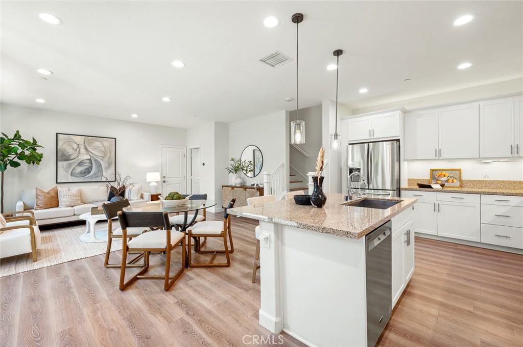 Welcome to 906 El Paseo, an elegantly upgraded residence nestled in Foothill Ranch gated community. Ideally situated across from the community greenbelt and cabana, this home offers enhanced privacy, abundant natural light, and an exceptional setting within the neighborhood. The home has been recently refreshed with brand new luxury flooring and interior paint, creating a bright and welcoming atmosphere. The open-concept layout is perfect for both everyday living and entertaining, while the kitchen is equipped with top-of-the-line stainless steel appliances, including a recently updated microwave, stove range, and dishwasher. The spacious primary suite is a peaceful retreat, complete with a walk-in closet featuring custom built-in organizers, offering maximum storage and convenience. Smart upgrades include LED lighting throughout and a built-in EV charger, ensuring modern efficiency and ease of living. Residents of El Paseo enjoy access to resort-style amenities, including a pool, clubhouse, playgrounds, and well-maintained common areas. The home is also ideally located near top-rated schools, shopping, dining, and outdoor recreation. This is a rare opportunity to live in a move-in ready, light-filled home in the heart of Foothill Ranch.