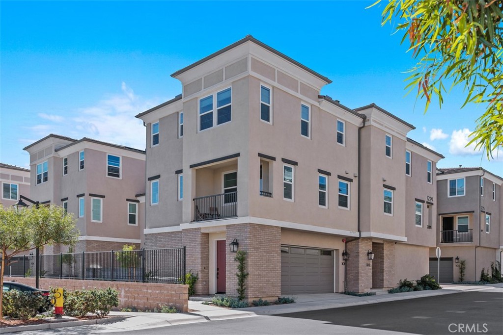 WOW, WOW & WOW!!! Check out this phenomenal, San Marcos like new condo (less than 2 yrs new) at an incredible price!!! Elevated on a hill with views, this end unit is ideally situated near front gate with guest parking by front door, mailboxes & pool/spa just across drive. Bright & airy with tall ceilings throughout & plenty of indirect lighting overhead. Spacious great room on 2nd floor opens to inviting kitchen island/breakfast counter featuring stainless steel appliances (refrigerator included), ample cabinetry storage & counter space. Enjoy views from your private balcony just off your living area. Also on main living area is a half bath with pedestal sink. Enjoy doing laundry with included stacked washer & dryer down hall from both bedrooms. Primary bedroom with views & ceiling fan is ample sized to hold a king size bed. Attached bathroom features dual sinks, lots of counterspace, compartmentalized commode, oversized shower & walk in closet. 2nd bedroom also with views & attached bathroom. Oversized 2 car garage with tall ceilings & direct entry into home, features EV hookup for charging, tankless water heater & solar which is fully paid for (perfect for keeping those electric bills lower)! Move in ready & just waiting for its new owner!