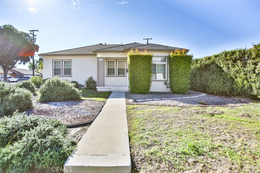 Welcome to 6851 Coachella Ave – A Beautifully Updated Corner-Lot Home in Long Beach! This charming single-story corner home offers 3 spacious bedrooms and 1 bathroom, perfectly combining modern comfort with timeless character. Step inside to a bright living area featuring re-stained wood floors, recessed lighting, and abundant natural light. The tile flooring in the kitchen and hallway adds both style and easy maintenance. The remodeled kitchen showcases quartz countertops, new cabinetry, designer tile backsplash, and stainless-steel appliances, ideal for everyday living and entertaining. The dining area features a new modern chandelier, adding elegance and warmth. The upgraded bathroom offers contemporary finishes and fixtures for a clean, refreshed look. Enjoy the outdoors in your large private backyard with a detached 2-car garage — or explore the potential to build an ADU and SB 9 unit for additional income, with finished renderings included. Additional highlights include a tankless water heater, fresh interior and exterior paint, and a long driveway providing ample parking. Situated on a quiet corner lot near schools, parks, shopping, and easy access to the 710 and 91 freeways, this move-in-ready home delivers comfort, functionality, and long-term value.