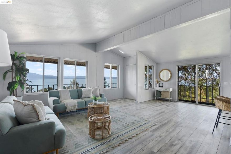 Tucked into wine country with jaw-dropping views of North America’s oldest lake, this newly renovated three-bedroom, two-bath home offers the ultimate blend of natural beauty and modern comfort. Inside, you’ll find fresh flooring, updated bathrooms, and a sunlit open-concept layout perfect for entertaining. A cozy stove anchors the living area, while oversized windows showcase that stunning lake view. The spacious kitchen offers ample storage and another postcard-worthy view to enjoy while you cook. The serene primary suite features a large ensuite with a soaking tub and walk-in shower for your own private retreat. Step out onto your private deck to sip coffee at sunrise or unwind under the stars—this is indoor-outdoor living at its best. With generous yard space for gardening, dining, or relaxing, you’re surrounded by peace and possibility. Just minutes from farm-to-table dining, wineries, and year-round outdoor adventures like swimming, canoeing, and hiking. With clean air, rich history, and endless recreation, Lake County invites you to breathe deeper and live better.