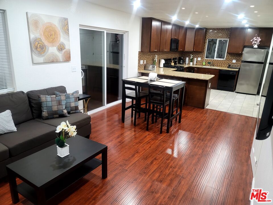 SHORT-TERM RENTAL, Daily rate ($150 - $400) weekly ($1050 - $2863) Furnished rental with 4 Bedrooms (Room 1: Queen bed with Smart TV) (Room 2 & 3: 2-Twin beds & Smart TV in each room) (Room 4: Full bed with Smart TV) & 2.5 Bathrooms and a 1200 sq. ft. of private roof deck in LA - Miracle Miles next to Beverly Hills, Pacific Palisades & Hollywood Hills. FIRST FLOOR..... comes with an open furnished living room and dining area that leads to a spacious kitchen with stove, oven, microwave, dishwasher, fridge and half bathroom. SECOND FLOOR...Master bedroom... has Queen size bed with flat screen smart - cable TV & Separate shower & tub, enclosed private toilet & double sink bathroom ...2nd & 3rd bedrooms... EACH has 2 furnished twin beds with flat screen smart - cable TV, ...4th bedroom... furnished with a full bed with flat screen smart - cable TV. Plus a Full bathroom with shower/tub, toilet, double sink and washer & dryer. THIRD FLOOR... office area and 1200 sq. ft. of private roof deck with view of Hollywood. House is equipped with a central heating & cool system. Great Airbnb, booking.com & VRBO