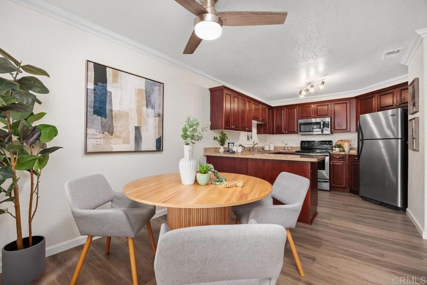 Welcome to Vista Way Village—a gated, peaceful, resort-style community offering comfort, convenience, and upscale coastal living. This 1,093 sq ft, 2-bedroom, 2-bathroom condo has been tastefully updated and is move-in ready!  This TOP LEVEL UNIT enjoys a beautiful modern kitchen featuring rich cherry wood cabinetry, granite countertops, and stainless steel appliances. BRAND NEW LVP FLOORS. The open layout flows into a spacious living and dining area with luxury wood-style flooring, crown molding, and stylish lighting. A large peninsula counter is perfect for everyday dining or entertaining.  Garden-style window nook—a peaceful spot ideal for indoor plants or relaxing with a view of the greenery outside.  Interior Highlights:  Updated kitchen with granite countertops & stainless steel appliances.  Cherry wood cabinets with ample storage.  Bright, open-concept living space.  Crown molding and wood flooring.  Cozy living room fireplace.  Large bedrooms with walk in closet.  2 full bathrooms with modern fixtures.  Large, private covered patio.  In-unit laundry.  1 private garage + 1 assigned parking space.  Vista Way Village Community Amenities: Gated community with controlled access.  2 sparkling pools & 2 relaxing spas.  Large, fully equipped fitness center.  Spacious event space with kitchen – perfect for hosting gatherings.  Tennis court.  Play area.  Pet-friendly, lush landscaping, and walking paths.  Prime location near shopping, dining, freeways, and just minutes to the beach.  Community is FHA and VA approved!
