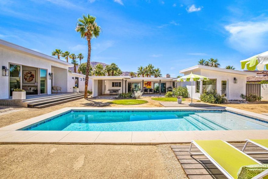 Delight in Mid-Century Ranch architecture on this expansive .35 acres with recent stylish updates, separate CASITA, and just 2 short blocks from El Paseo in desirable south Palm Desert. This newly remodeled 1950 MCM with NEW pool & spa plus NEW A/C has three private bedrooms including the poolside Casita, open concept great room, bonus room/study, & chefs kitchen with professional grade appliances, floating shelves & white marble waterfall countertop. Retreat to the primary bedroom with sitting area, walk-in closet & recessed lighting. Primary bath is completely Renovated with modern finishes & boasts double vanity, soaking tub & shower with direct access to pool & spa. The great room features gas-burning fireplace with modern tile design, new tile flooring & mountain views.Connected by a breezeway, the newly added Casita is en-suite with poolside views & offers the luxurious finishes of the main home, while the oversized garage has epoxy floors & additional parking in the drive. Outside, enjoy heated pool & spa, large lounge area & covered dining all nestled in the private landscaped desert gardens. The perfect location for your desert getaway.