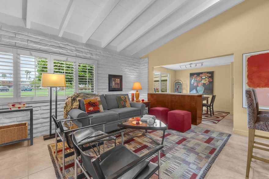 Rarely available and incredibly charming ''dollhouse'' boasting vaulted beamed ceilings, sleek tile flooring and custom features galore.  The only unit of this type with 2 bathrooms. You'll love the plantations shutters, cozy outdoor living spaces, 3 skylights, built-in gas wall fireplace and original checkerboard ceiling design in the great room.  Located in a quiet location, this one level home with no steps is close but not too close to the pool & spa. The newer mini-split HVAC system is perfect for lower utility bills plus you have your own interior washer & dryer. Each unit has a designated carport with storage above.  Situated on over 12 acres Desert Braemar is a low density co-op community, called the 'hidden gem of the desert'. Every amenity is yours including pool/spa, gym, library, workshop, tennis/pickleball, putting green, lawn bowling, shuffleboard, clubhouse with amazing kitchen and terrace, on site manager M-F. Your co-op monthly fee includes all amenities, maintenance, water, sewer, trash, Spectrum high speed internet plus cable including HBO and Showtime AND YOUR PROPERTY TAXES!  55+ community. Desert Braemar is a Stock Cooperative and each owner is issued a 'stock certificate granting a specific number of shares of the complex with exclusive use of a particular unit.  Cash sales only.  Better hurry on this one before it gets away!