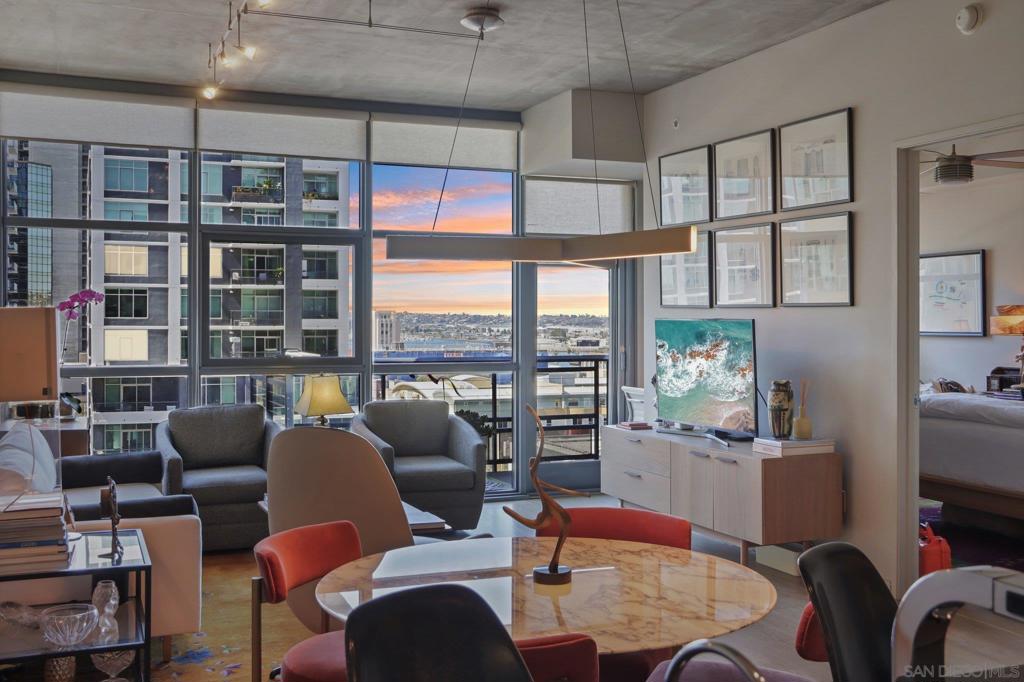 Welcome to one of the most sought-after larger one-bedroom residences in Aperture, perfectly situated in Little Italy. This highly upgraded condo offers an ideal blend of vibrant city living and peaceful retreat and is located just steps from the farmer's market, restaurants, FIT gym and a Whole Foods to open early 2026. You will find a generous, open floor plan that showcases floor-to-ceiling windows framing stunning bay views and breathtaking sunsets. European oak hardwood floors throughout the space, a custom-built desk, window shades, and a statement light fixture in the dining area. The balcony has plenty of room for a cafe table and chairs, including a custom screen door to enjoy the western breezes. The large, modern and updated kitchen features newer appliances, sleek high end Dekton countertops (modern stone material of glass, porcelain, and natural quartz create a high-quality, durable surface), high-end fixtures, custom backsplash, and updated lighting. Relax in the king-sized bedroom with a cozy sitting area and partial bay views. The spacious, custom walk-in closet boasts built-in drawers, a hamper, and floor-to-ceiling shoe rack, with plenty of additional storage. The remodeled bathroom has a glass-enclosed stand-up shower, Toto toilet, bidet, Dekton countertops, designer fixtures, and new tile flooring. Additional features include a full-size stackable washer & dryer, one secure, underground parking space and a relatively low HOA fee. This beautifully appointed, turnkey condo is an exceptional opportunity for sophisticated urban living.