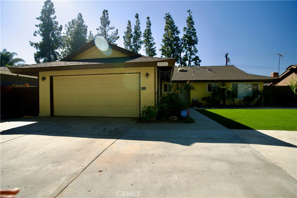 Great Single Family Residence in the Beautiful city of Riverside! This warm home has an open floor plan. The remodeled kitchen leads to the living room that has a chimney and a sliding door that provides access to the covered patio. Four spacious Bedrooms, two of the bedrooms have their own bathroom and there is a third bathroom in the hall. Air Conditioning System was recently replaced, the roof was installed about seven years ago, the front yard has synthetic grass and concrete slab that can be used as a front patio or parking space. The two car garage is attached and has direct access to the house. Laundry area in garage. This home is in a great location: near shopping centers, restaurants, public transportation, etc. You will love this home!