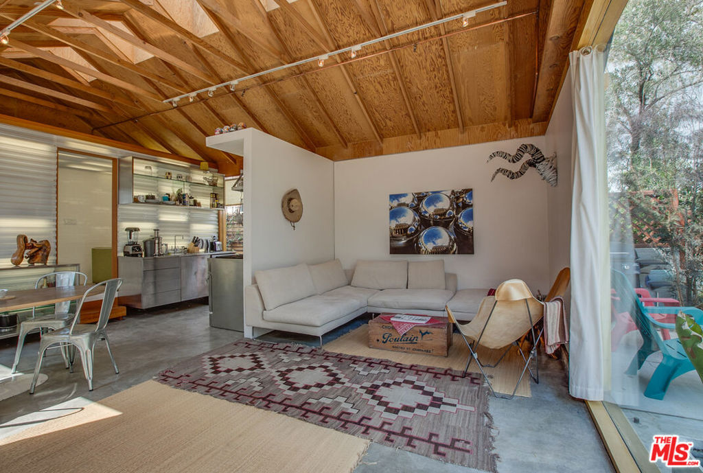 Award-winning architectural contemporary featured in DWELL magazine! This one-of-a-kind beach bungalow offers a striking blend of design, light, and privacy in a prime Santa Monica location. Gated and fenced for seclusion, the home showcases floor-to-ceiling glass walls, a stainless steel kitchen, security system, and remotely operable skylights for year-round energy efficiency. The spacious layout includes one large bedroom and a beautifully designed bath with both tub and shower. Great natural light throughout enhances the modern lines and warm finishes. Located moments from Rose Avenue, Main Street, Whole Foods, and just blocks from the sandthis unique home is the perfect blend of innovation and beachside lifestyle.