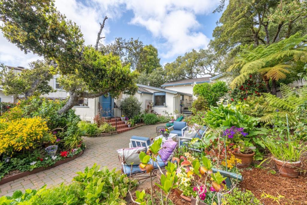 Escape the heat! A Rare Opportunity to own a Cool Coastal Retreat in the Heart of Carmel by-the-Sea. Location, location, location... and Legacy! Just three blocks to downtown Carmel Plaza, this delightful Carmel cottage is move-in ready and offers the opportunity to enjoy the true Carmel LifeStyle now, while leaving a legacy for your children and grandchildren for years to come. Mainly a single-level home (four steps to the Primary Bedroom), this home is set back from the street behind the garage and garden and tucked far back from Ocean Avenue. It is surprisingly quiet, and noise has not been an issue for the owners while living here. The oversized lot has room to expand. This authentic 1930's Carmel Cottage offers a rare sense of seclusion in one of Carmel's desirable locations, with easy access to Highway One and the Monterey Airport, while avoiding downtown traffic. The home features a beautifully landscaped garden and multiple patio areas ideal for entertaining or enjoying peaceful moments throughout the day. Whether you're hosting guests or seeking quiet solitude, this property provides a unique blend of indoor-outdoor living and timeless Carmel appeal, just minutes from world-class dining, shopping, and the stunning Central Coast shoreline.
