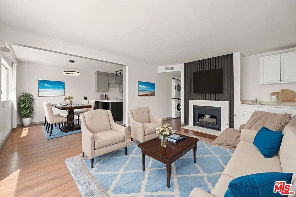 Introducing 15015 Sherman Way #316 - a top-floor condo in the vibrant center of Van Nuys. This well-proportioned 2-bedroom, 2-bath home offers 938 sq ft of living space designed for comfort and functionality. The sun-filled living room showcases laminate floors, a charming decorative fireplace, and custom built-ins, seamlessly connecting to the dining area and kitchen. The kitchen features classic wood cabinetry, generous counter space, and ample storage. Two spacious bedrooms sit down the hall, as well as a hall-bath with tub and shower. The primary suite includes a walk-in closet, en-suite bath, and a private balcony for outdoor relaxation. Added conveniences include all major appliances, in-unit stackable laundry, and central heating and cooling. The unit also comes with two assigned tandem parking spaces in a secure, gated garage. HOA dues cover essential expenses, including trash, water, landscaping and hazard insurance. Set close to shopping, dining, transit, and neighborhood amenities, this residence is perfect for first-time buyers, those seeking to downsize, or investors looking for a solid rental opportunity.